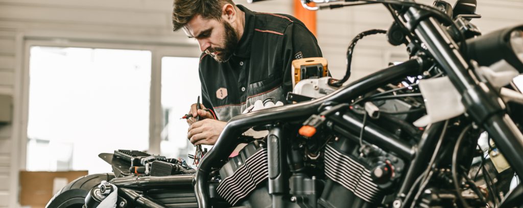 Mechanic looking over a motorcycle - Motorcycle Repairs Brixton